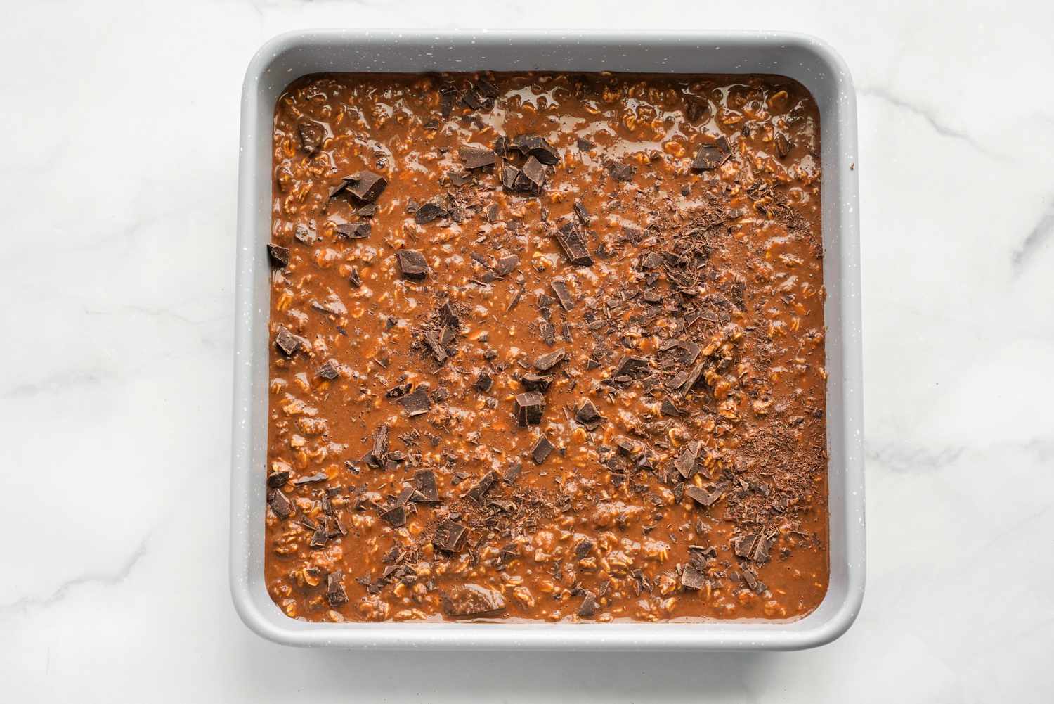 Baking Pan of Vegan Brownie Baked Oatmeal Topped with Chopped Chocolate 