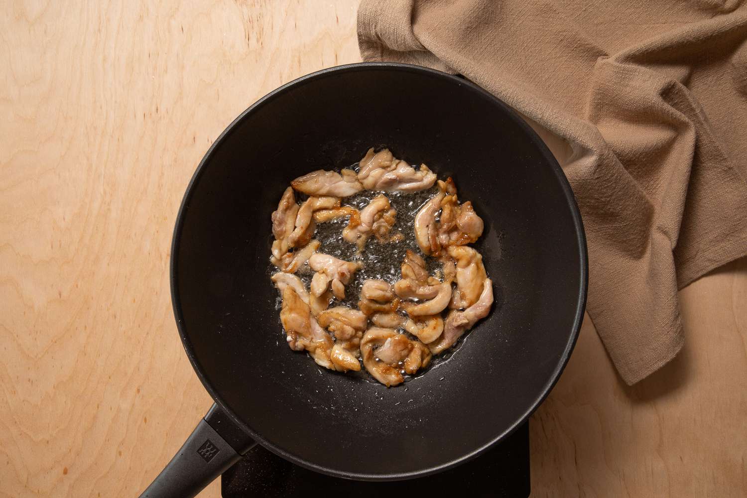 chicken cooking in a wok for pad see ew recipe