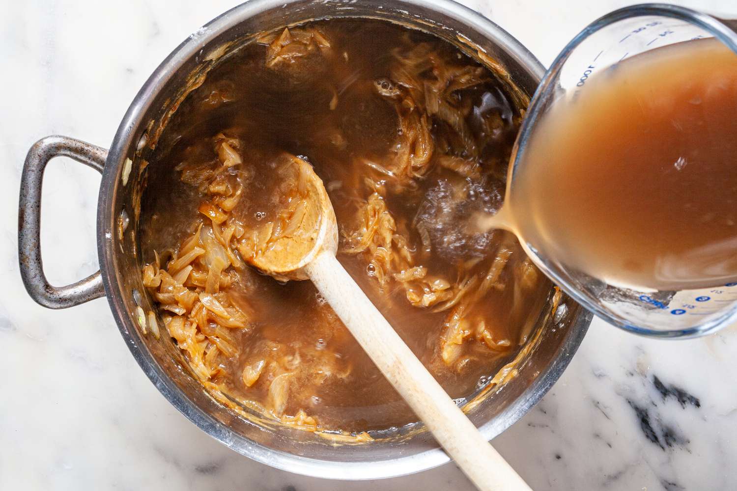 Add broth and herbs to caramelized onions.