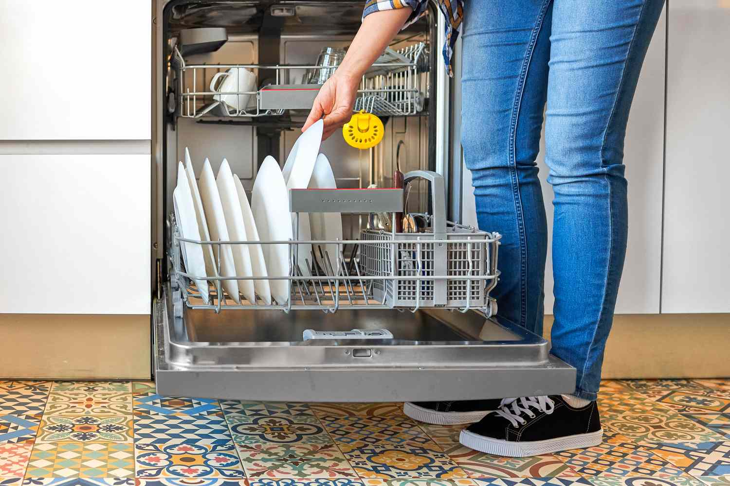 Woman unloading dishwasher