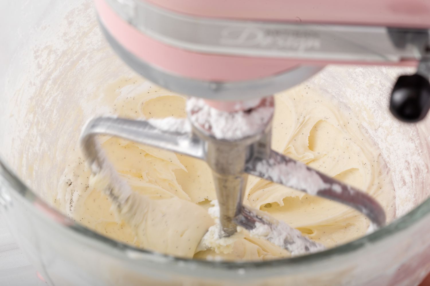 Making buttercream for vanilla cupcakes in a stand mixer.