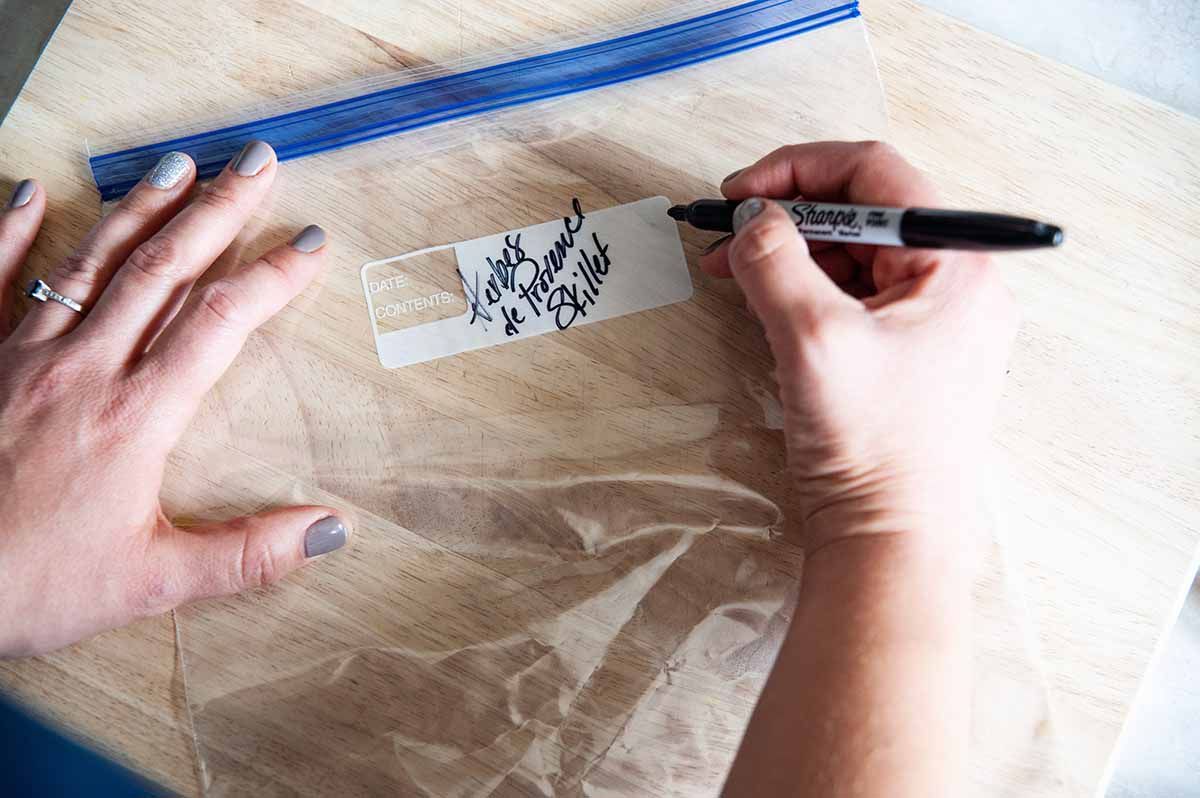 Skillet Chicken -- hands labeling a zip top bag