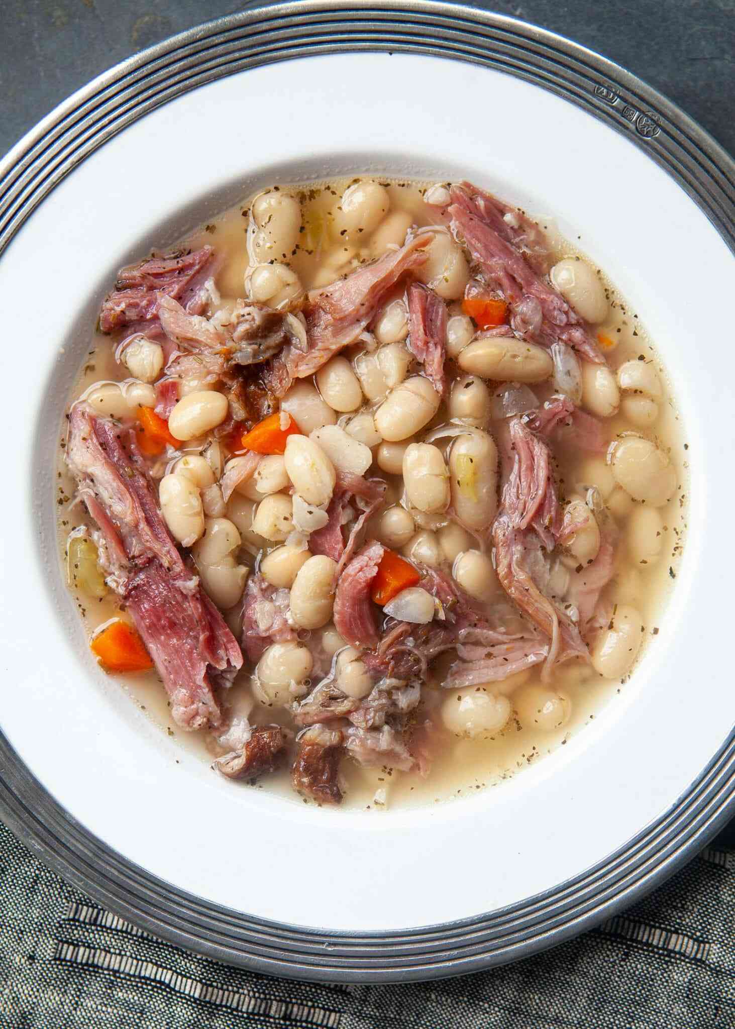 ham and bean soup served in a white bowl