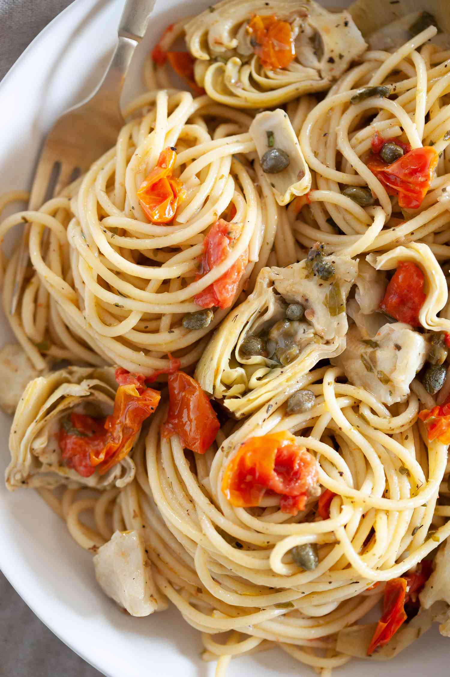 One-Pot Spaghetti with Tomatoes, Artichokes, and Capers in a Bowl