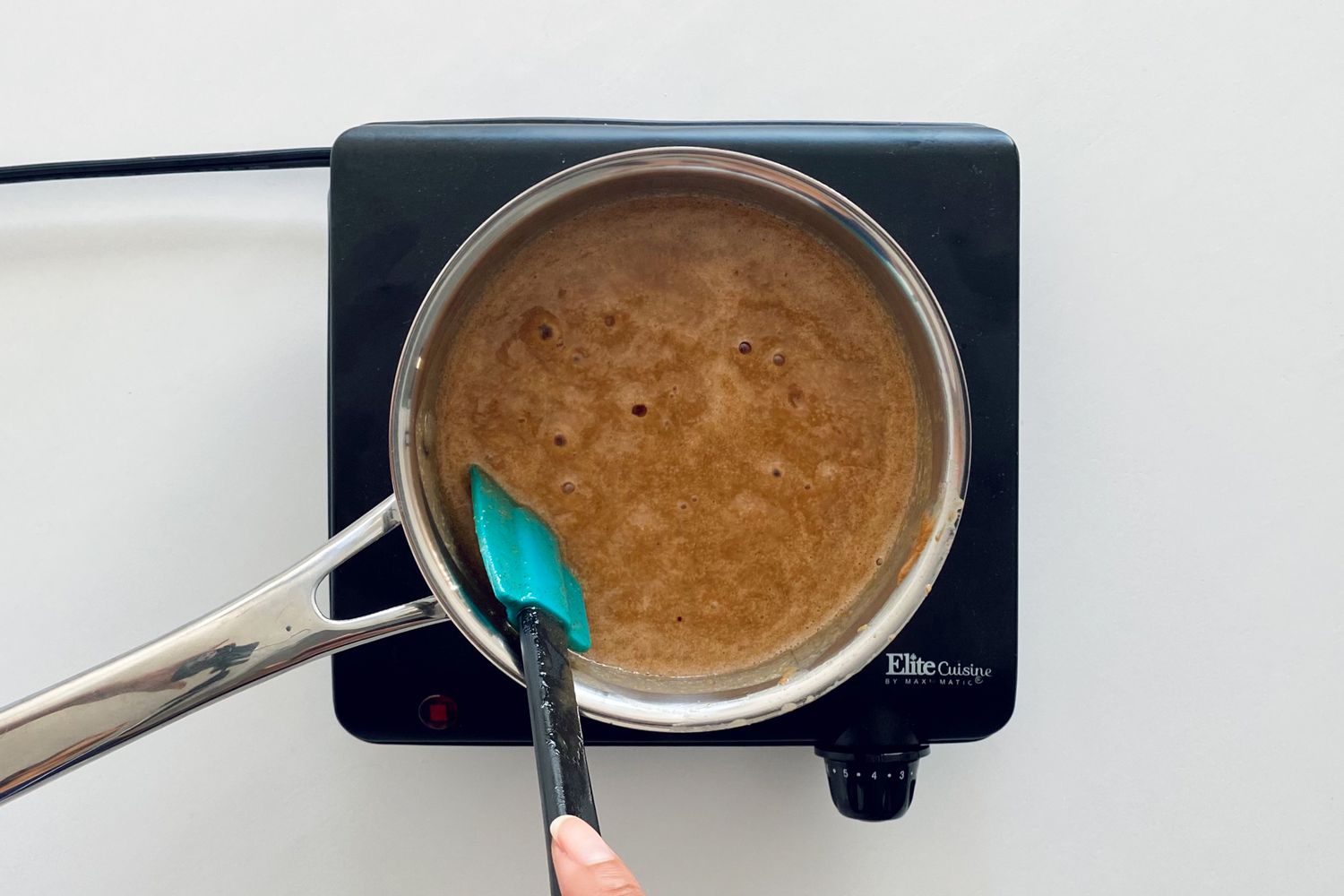 Simmering syrup mixture in a pot for Chewy Granola Bars with Dried Fruit and Nuts.