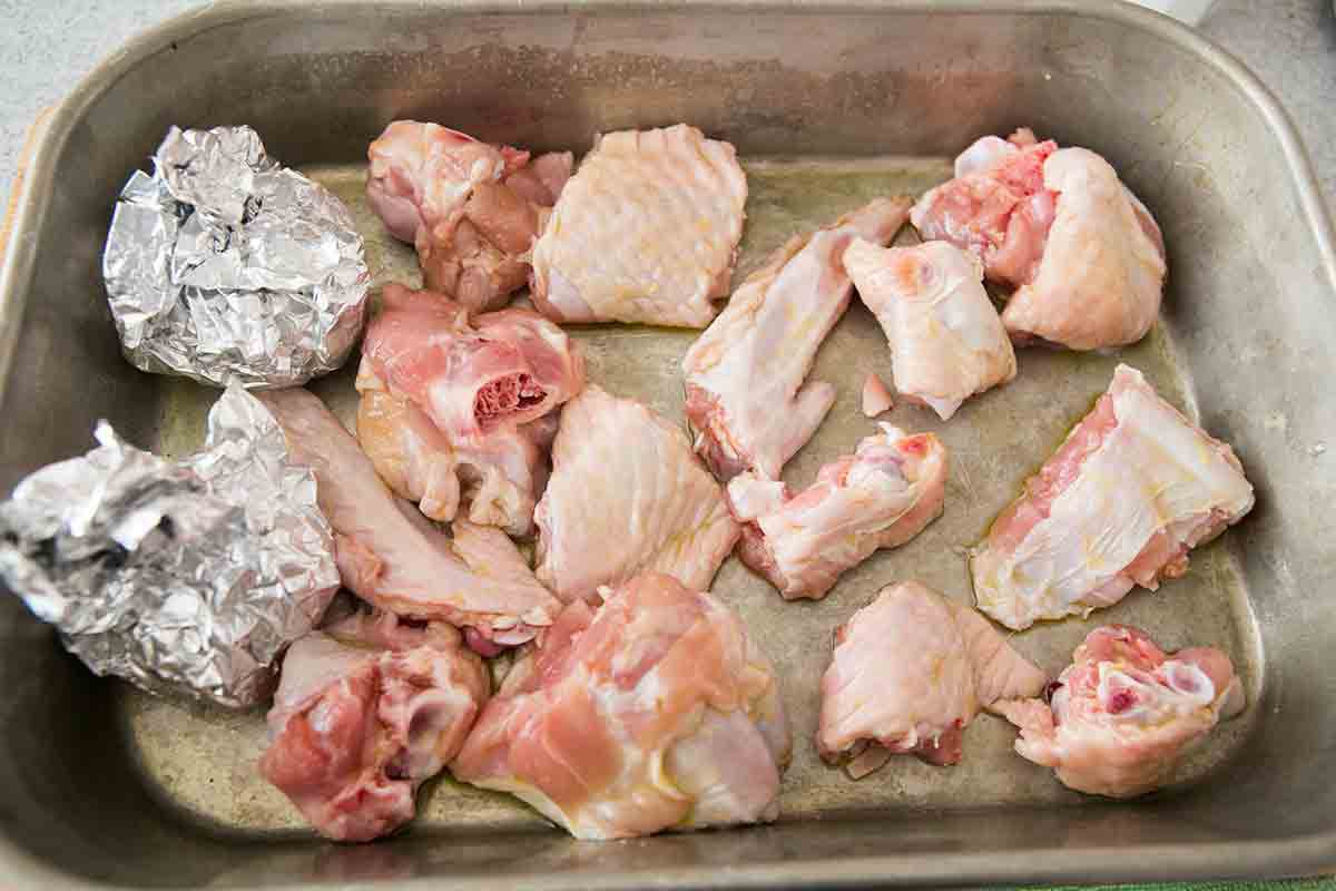 arrange foil wrapped garlic and chopped turkey wings in roasting pan