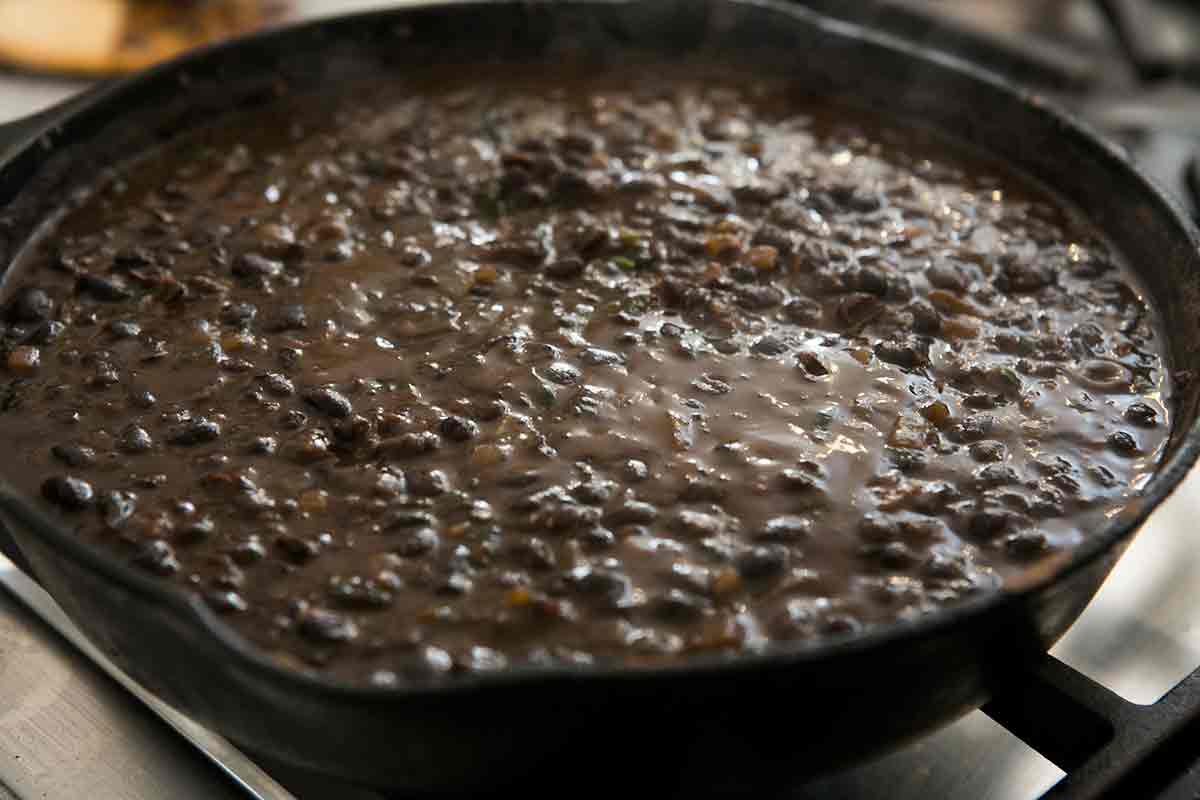 add cooked black beans and mash them