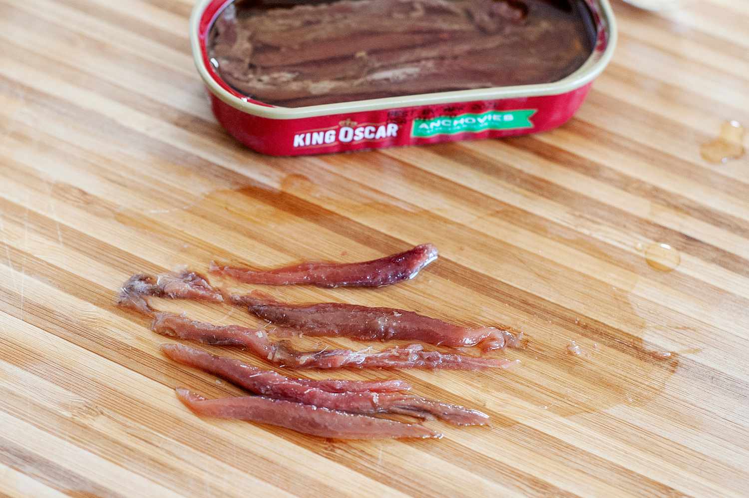 Anchovies set on a table to make Salad Dressing with Anchovies and Dijon .