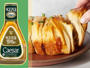 Caesar dressing bottle next to sliced pullapart bread