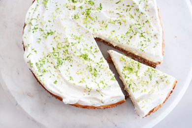 A slice of key lime cheesecake cut out. 