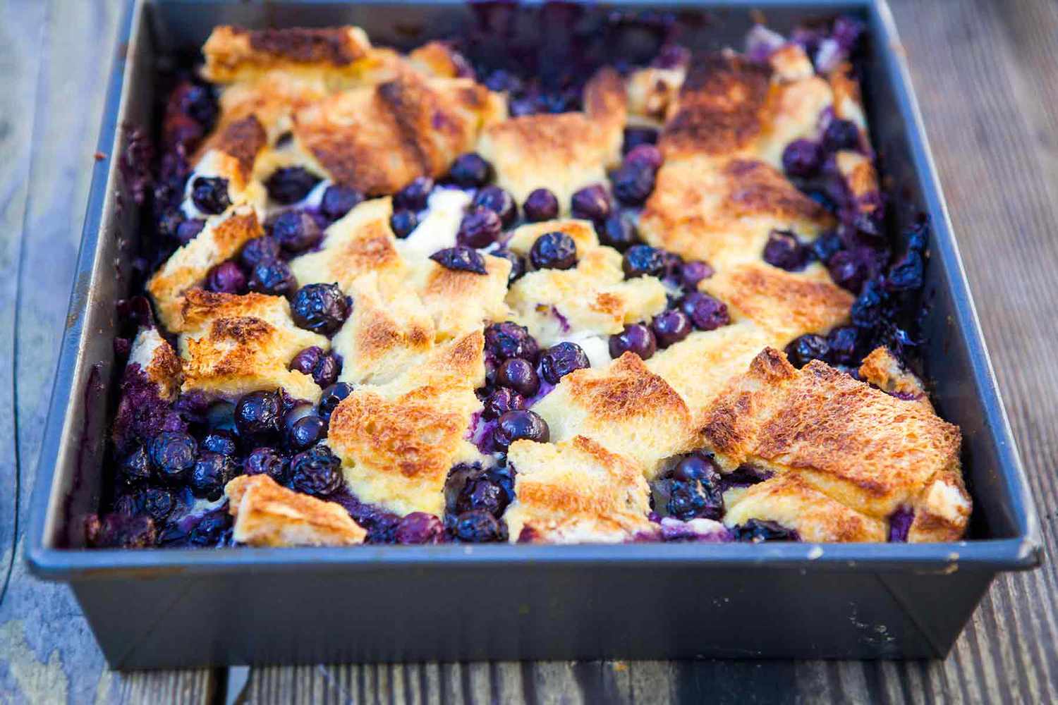 Blueberry maple breakfast bake in a metal baking pan.