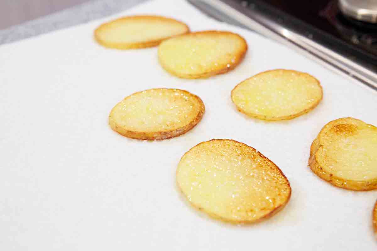 dry fried potato slices on paper towel for spanish tortilla
