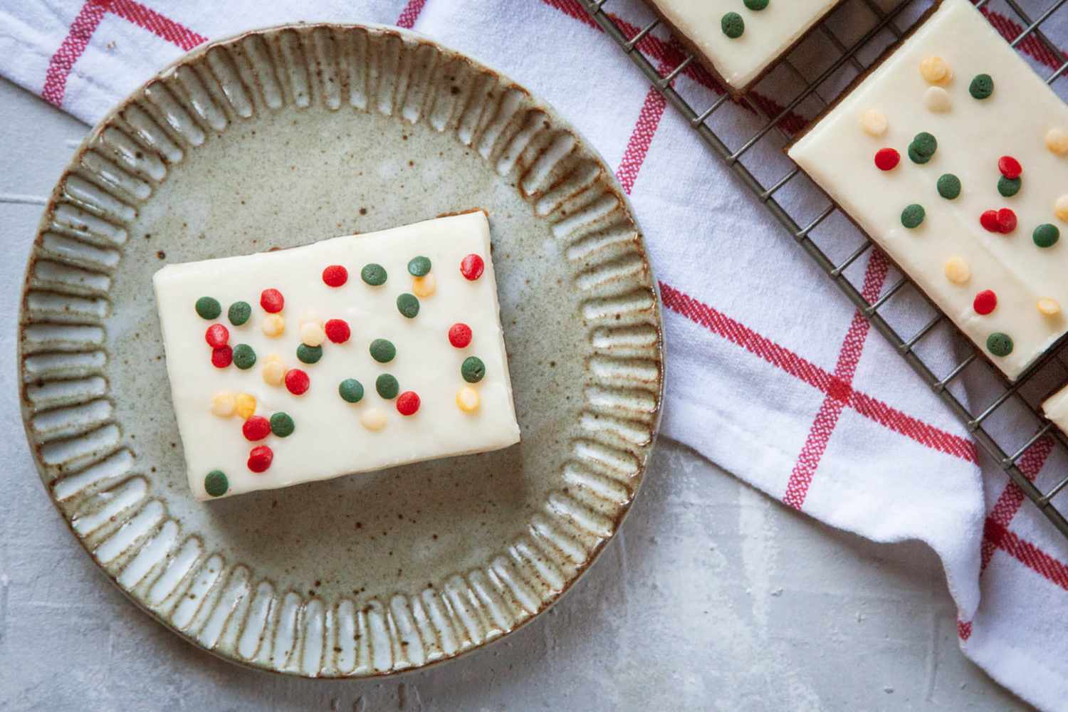 Overhead view of the Best Gingerbread Bars on a plate and topped with sprinkles and frosting.