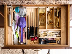 A kitchen drawer full of utensils and tools