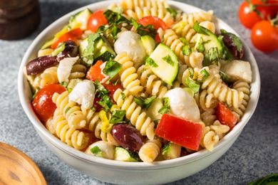 Bowl of pasta salad with vegetables and olives