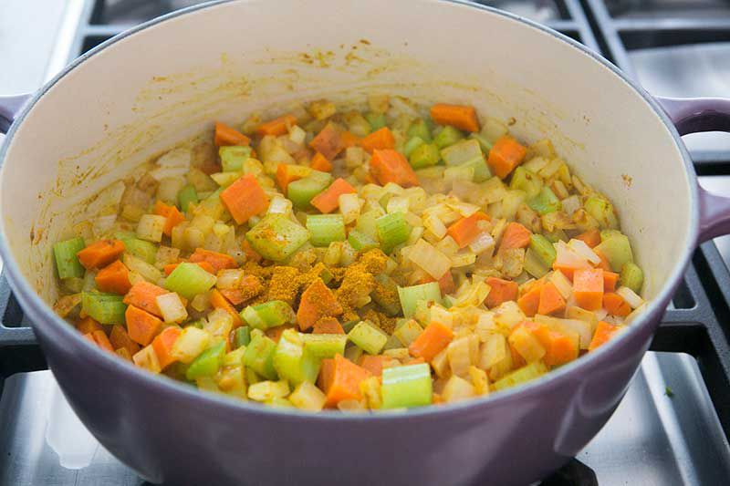 Sautéed onions, carrots, and celery with spice in a Dutch oven
