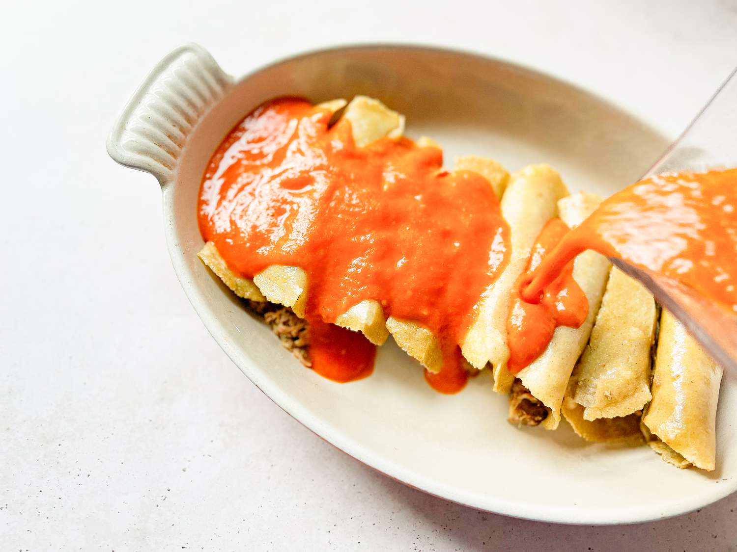 Sauce Poured over Pulled Pork Enchiladas 