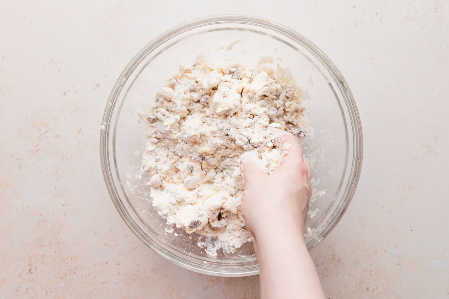 Cutting the butter into the dry ingredients to make a snowball cookie recipe.