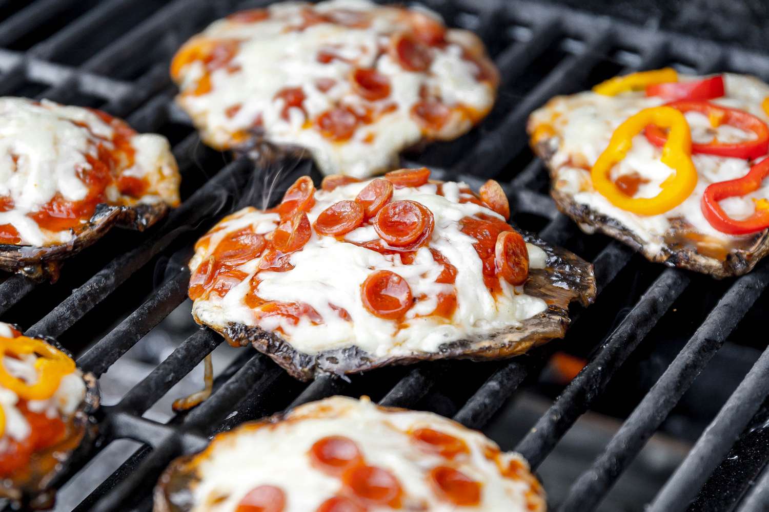 Grilled Portobello Mushroom Pizzas (Some Topped With Mini Pepperoni Pieces and Others Topped With Sliced Peppers)