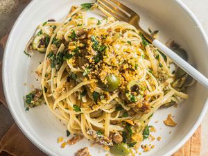 A plate of sardine linguine topped with breadcrumbs