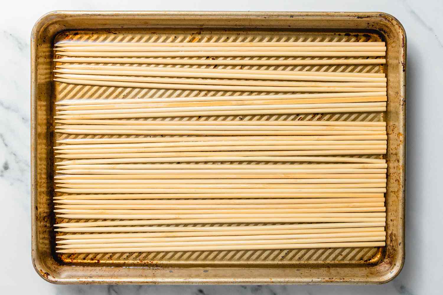 Bamboo Skewers Soaking in a Baking Pan for Cambodian Beef Skewers