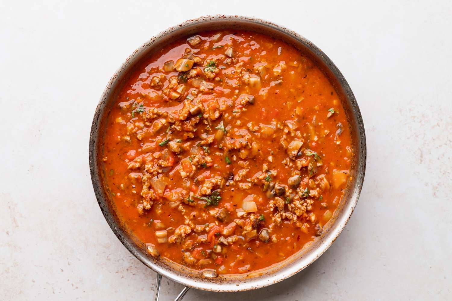 Tomato sauce simmering for a baked spaghetti recipe
