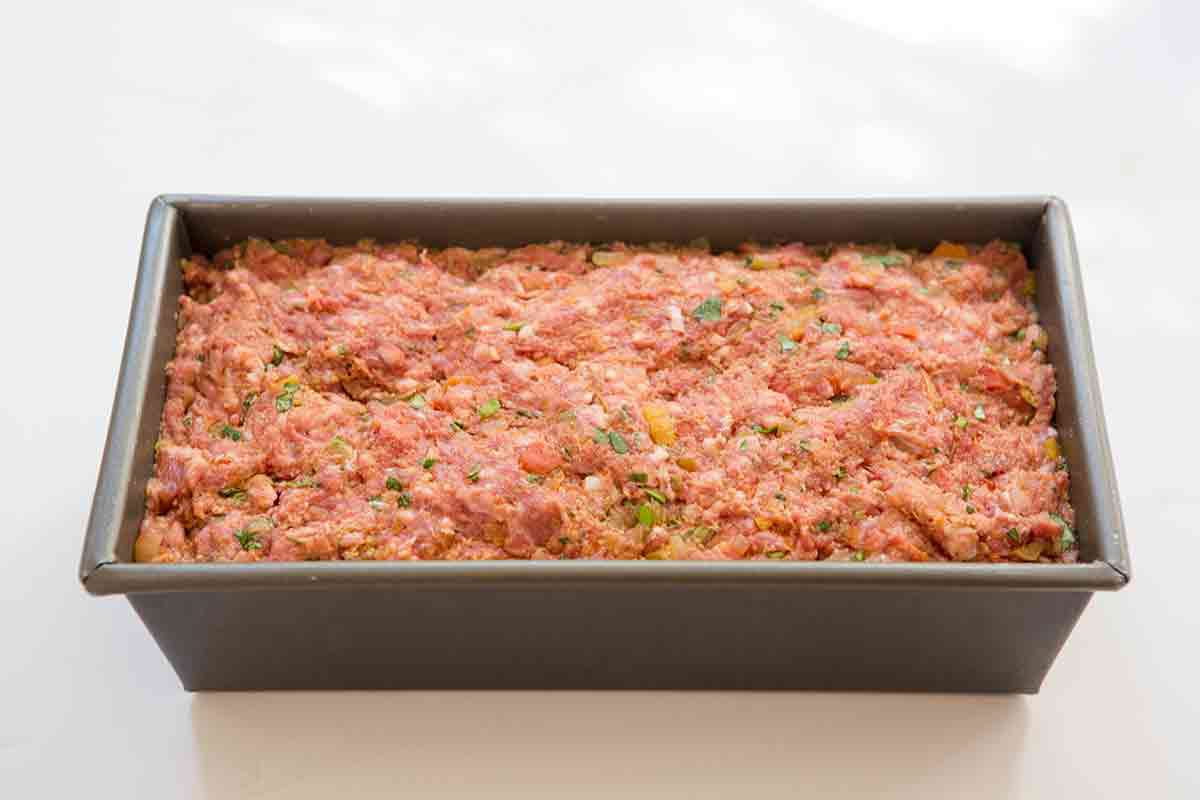 place moroccan meatloaf mixture into loaf pan