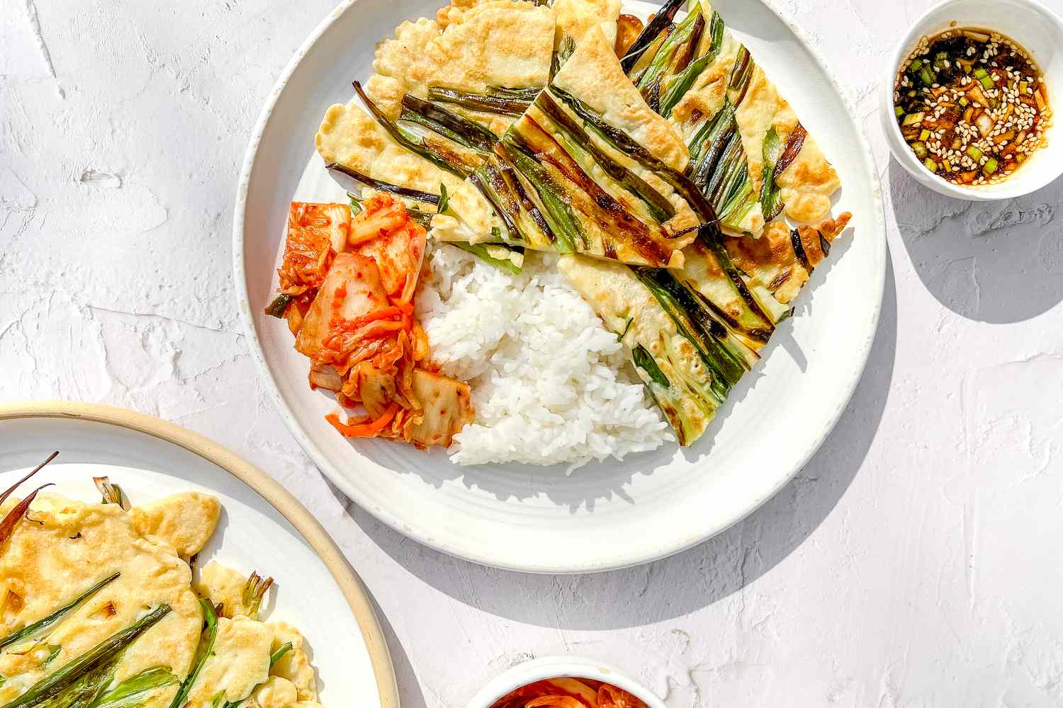 Pajeon, Kimchi, and Rice on a Plate Next to a Small Bowl of Sauce