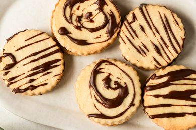 Round cookies decorated with chocolate patterns displayed on a surface