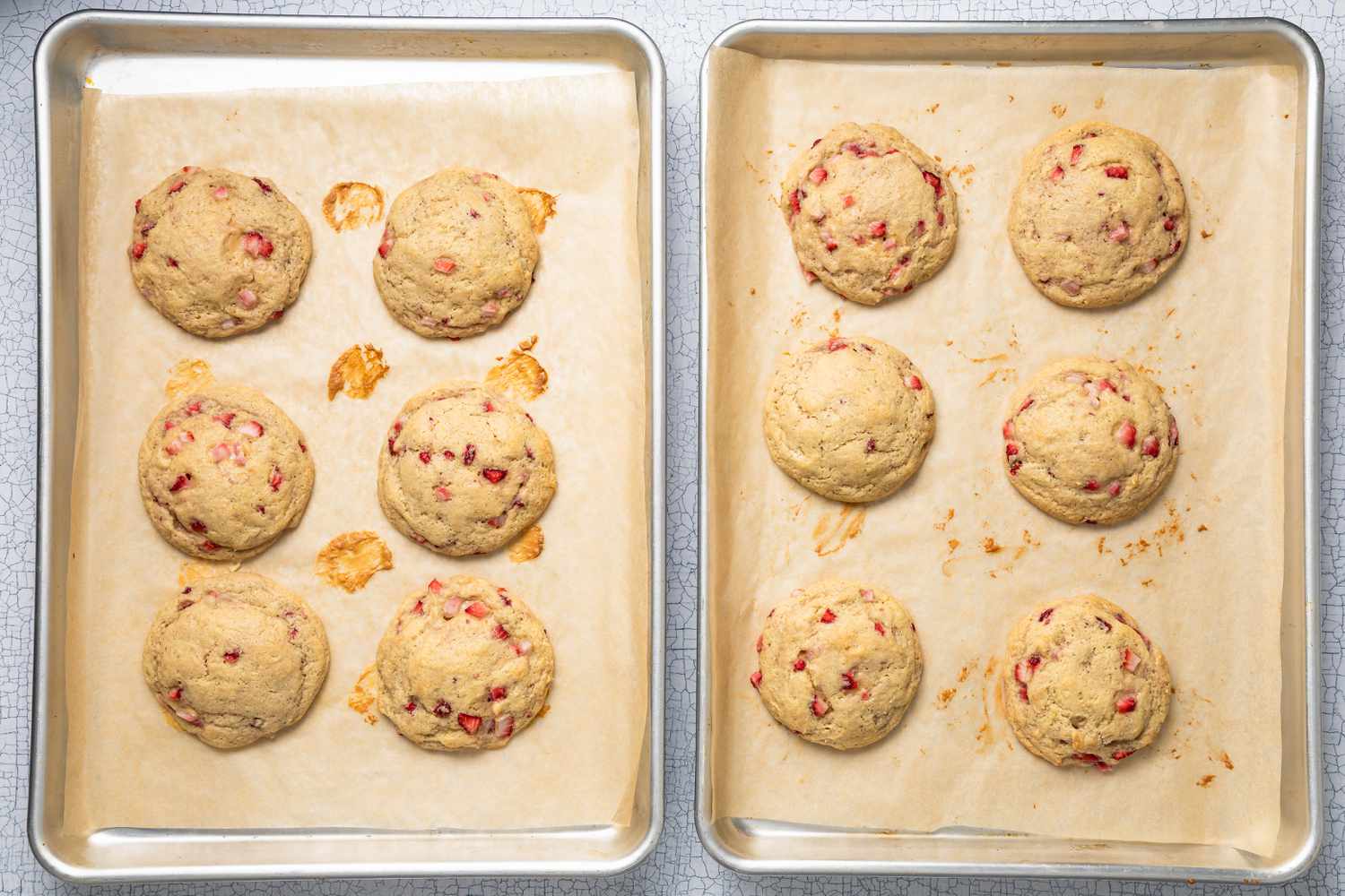 Baked Strawberry Cheesecake Cookies Resting on the Parchment Paper Lined Baking Trays