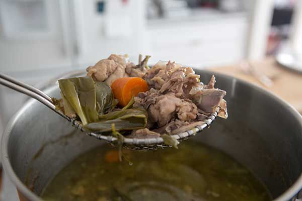 Removing solid pieces from cooked chicken broth