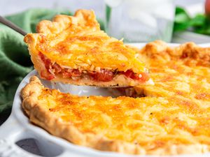 Tomato Pie with a Slice Lifted on a Pie Knife