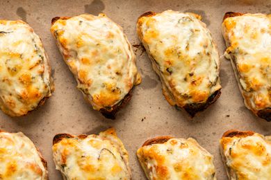 close up view of several Soupy Toasts on a parchment lined sheet pan