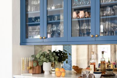 cabinets with glass doors, cups and glasses all stored neatly inside
