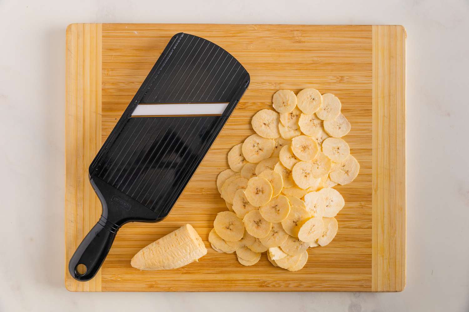 Plantain Sliced Using a Handheld Mandoline for Plantain Chips Recipe