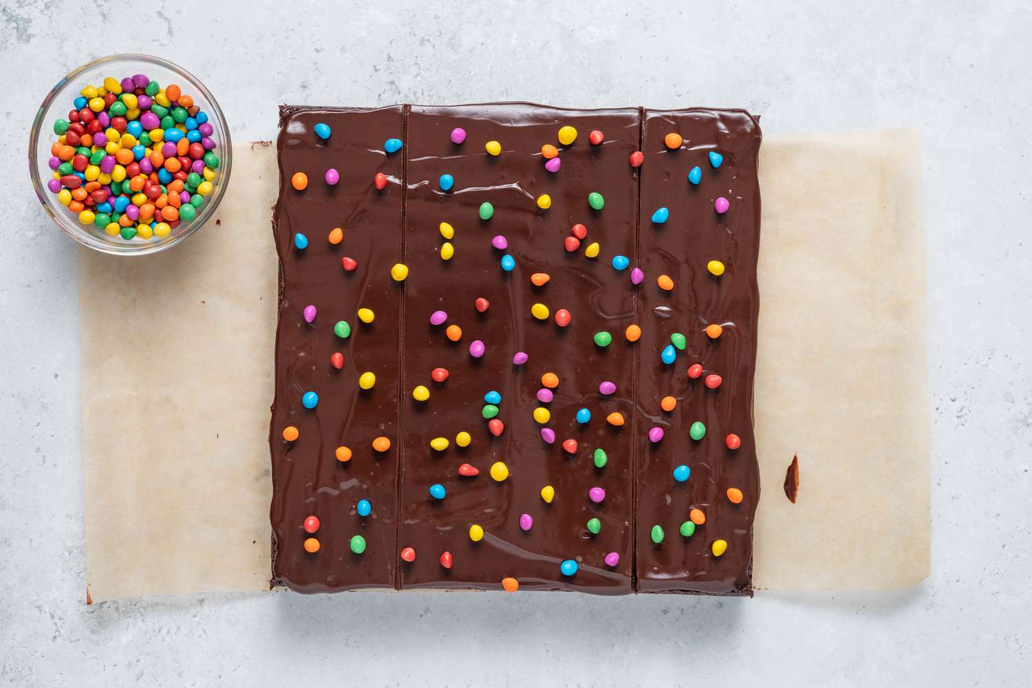Chocolate chip rainbow candy sprinkled on the homemade Cosmic Brownie and more in a bowl 