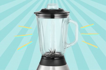 A countertop blender with a glass jar displayed against a radial gradient background