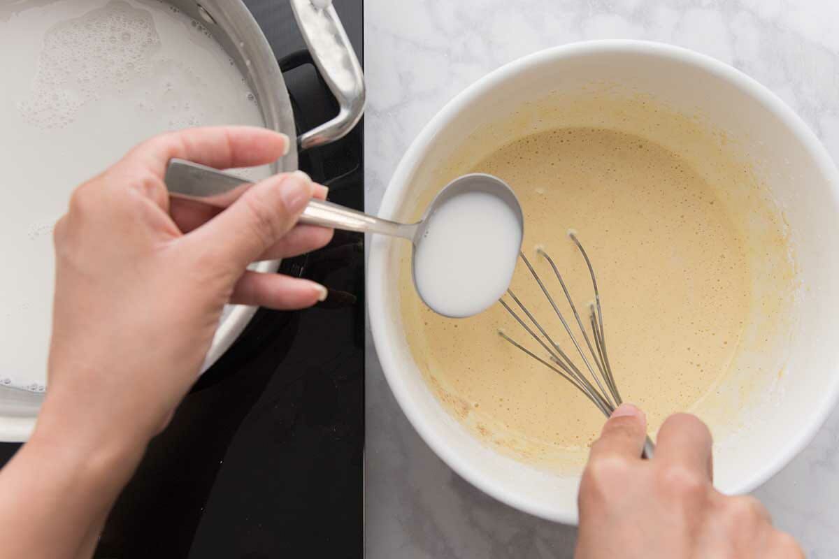 How to make coconut cream pie by slowly adding the warm milk to the egg mixture for the filling.