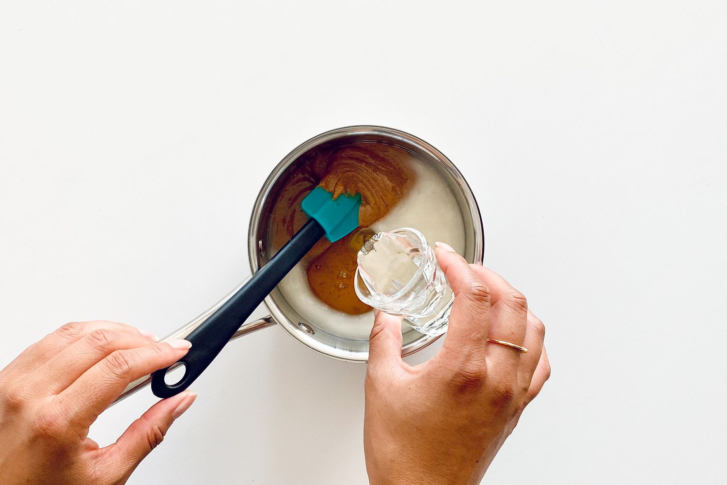 Adding corn syrup to pot for Chewy Granola Bars with Almonds, Dried Cherries, Pumpkin Seeds and Coconut Flakes.