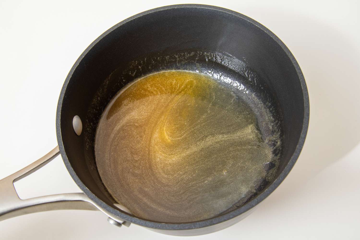 Honey butter in a saucepan for salted honey rolls recipe