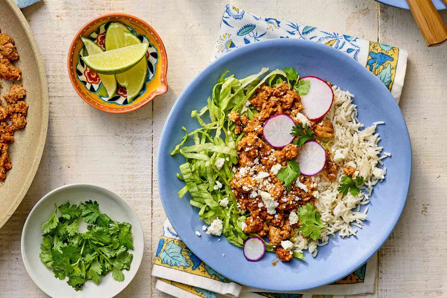 Ground beef turkey taco bowl with bowls of toppings