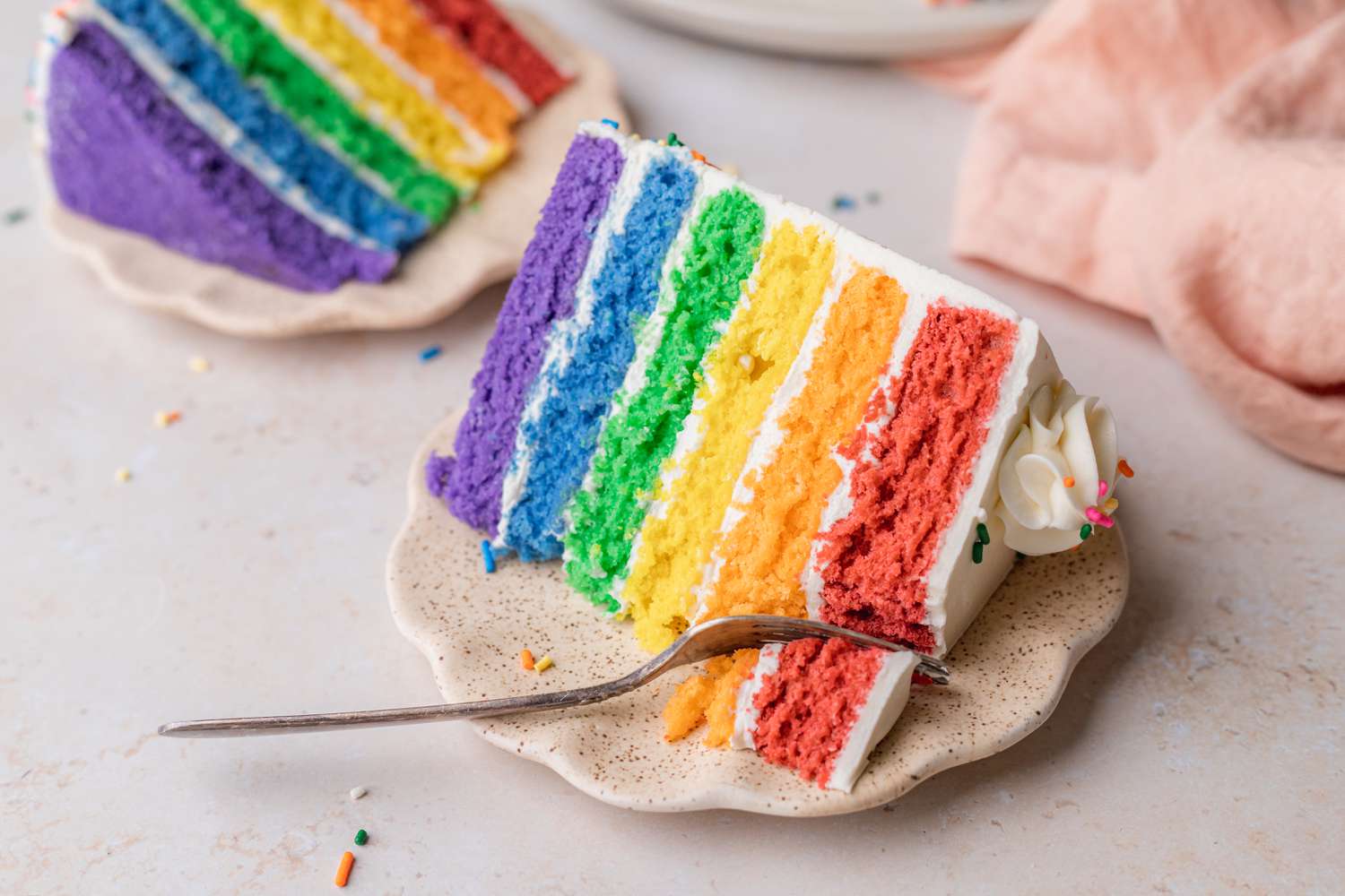 Rainbow Layers Cake on a Personal Plate with a Fork