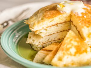 A stack of fluffy pancakes cut so that the inside layers are visible