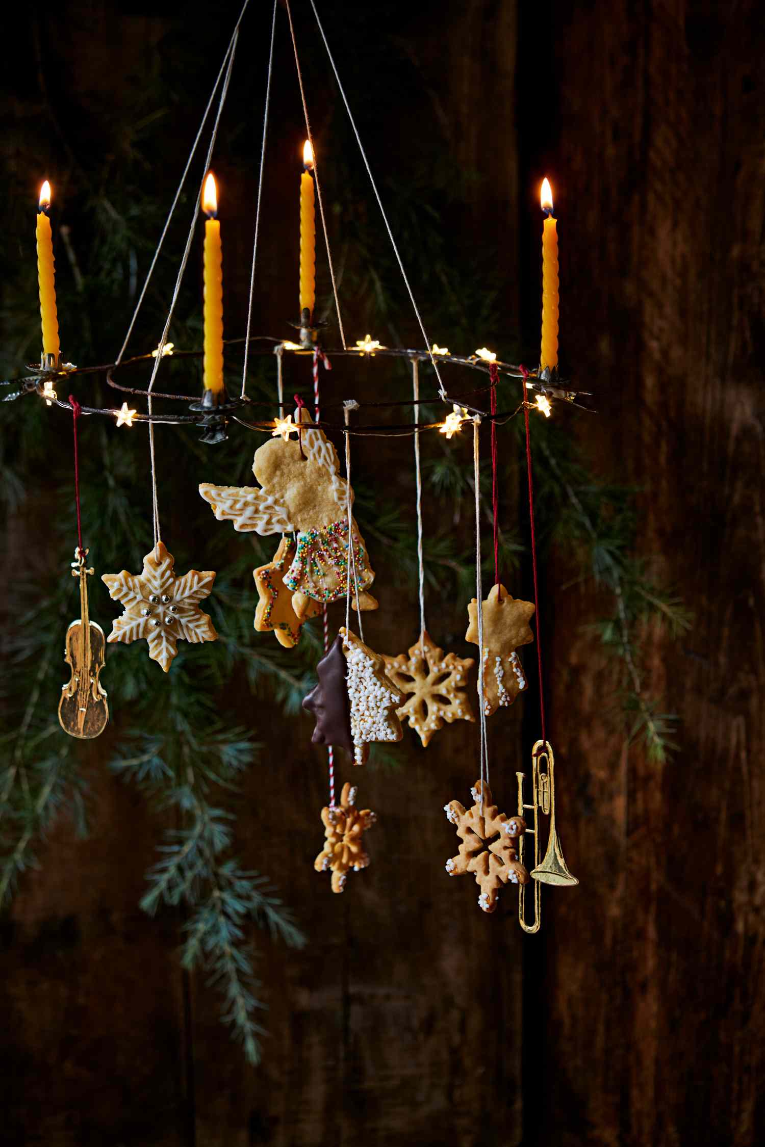 Decorative hanging display with lit candles ornaments and holidaythemed decorations
