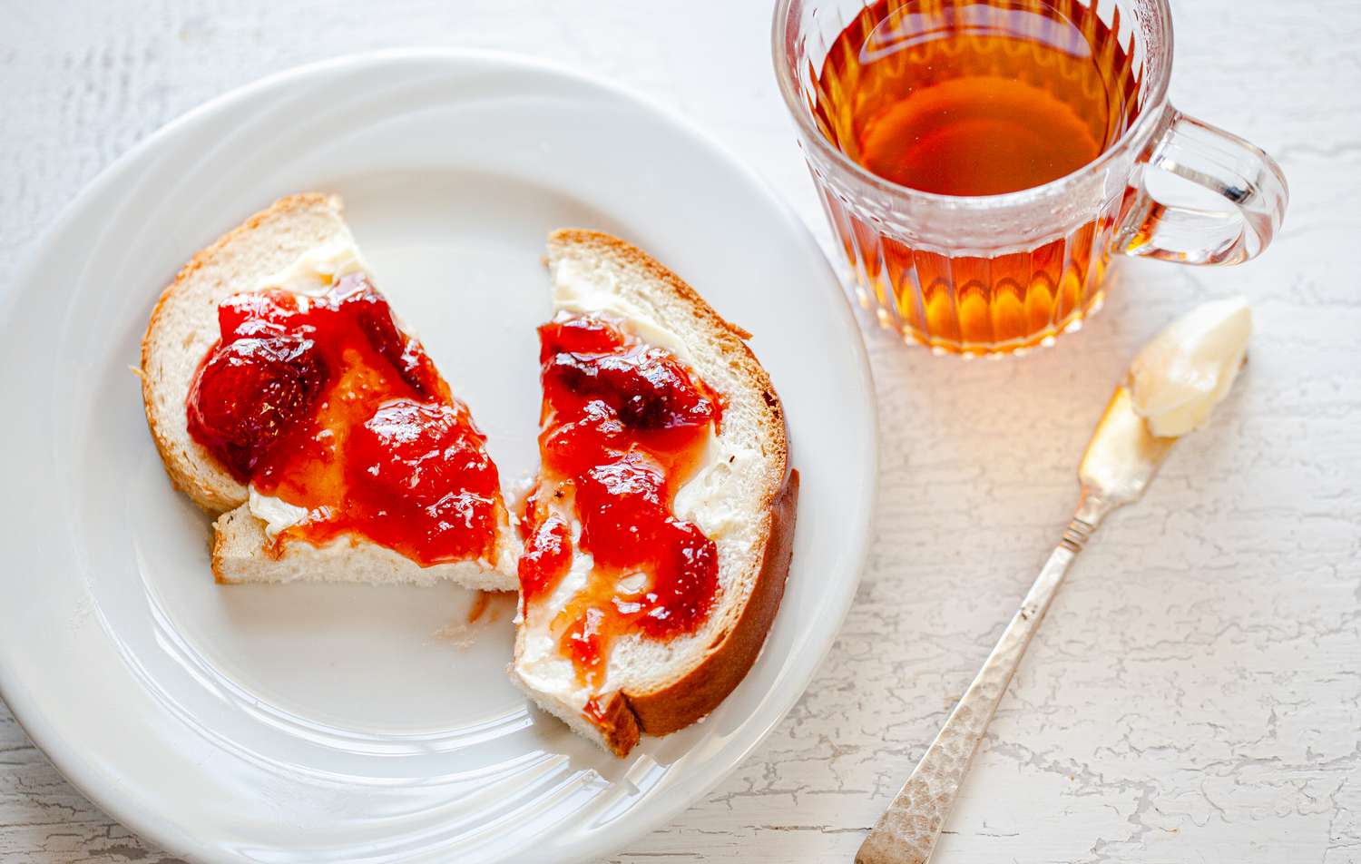 Peach, Pear, and Plum Jam on a Piece of Toast with Butter