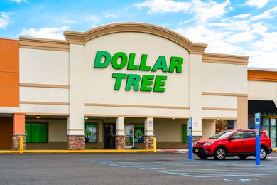 The exterior of a Dollar Tree store with a parked car