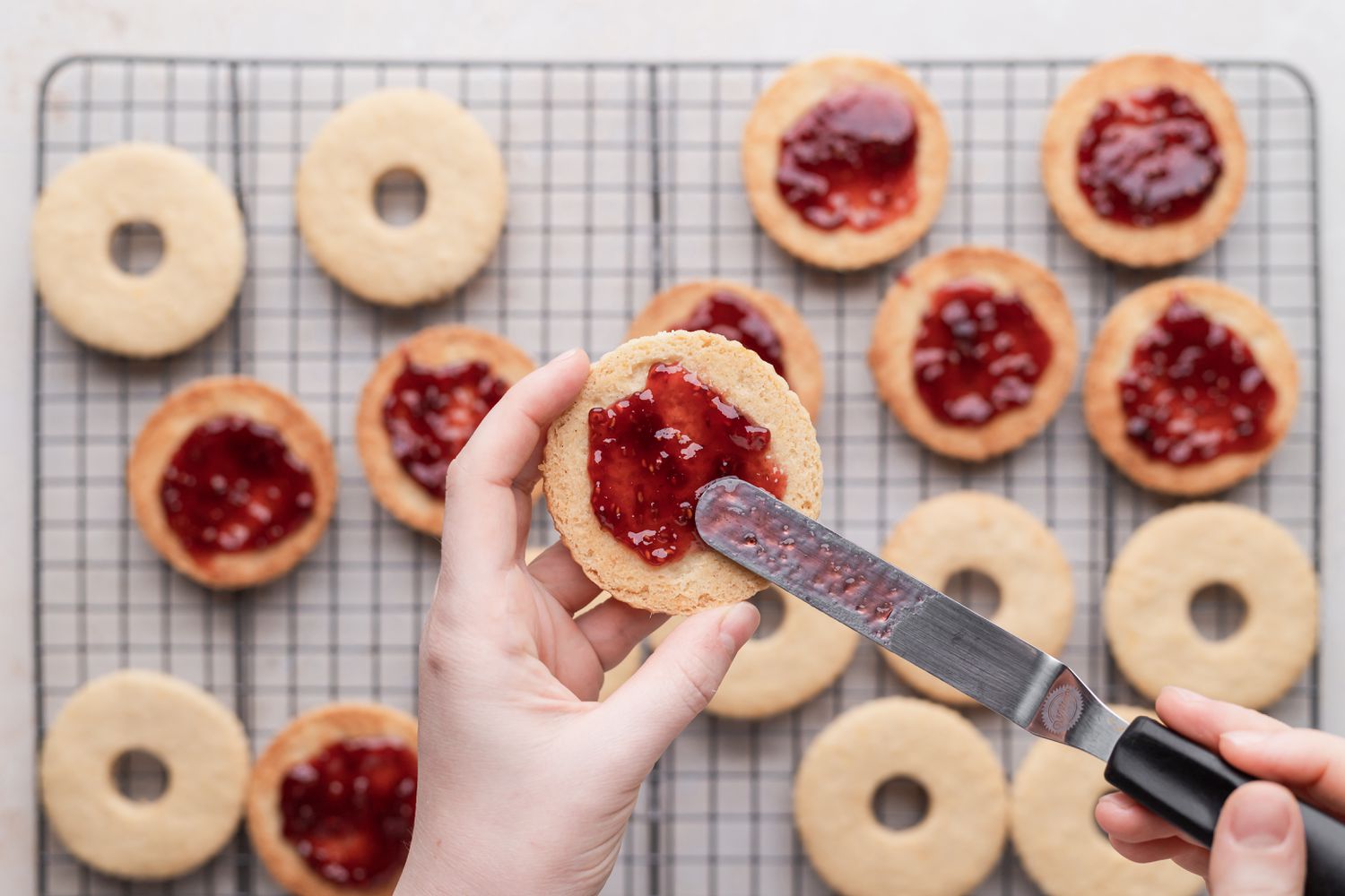 Spreading jam to make classic linzer cookies.