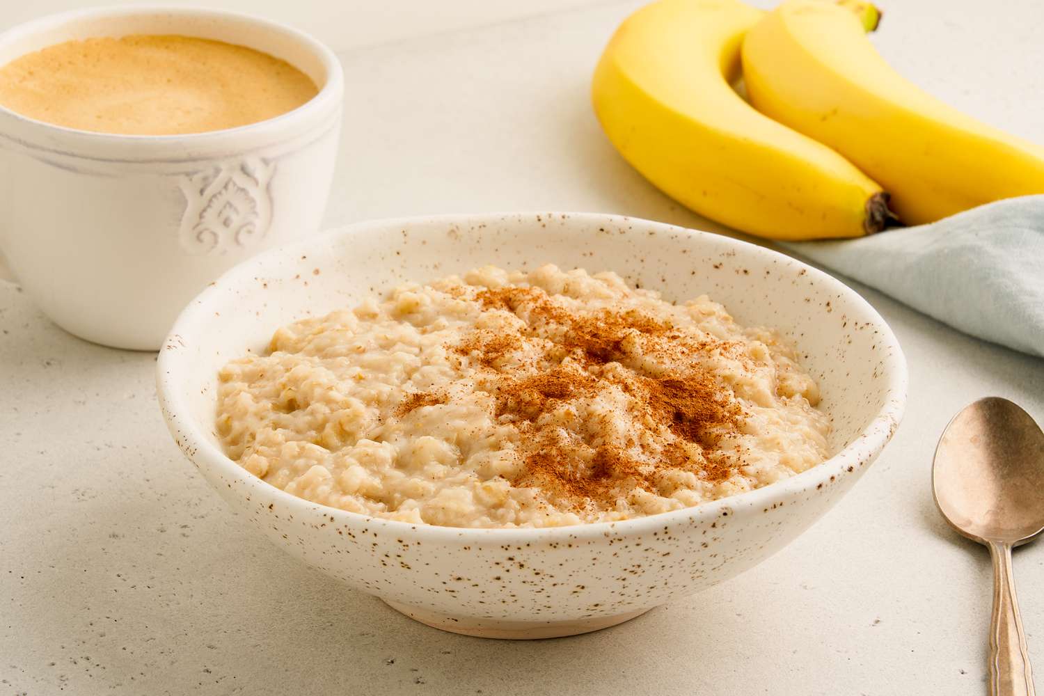 Sideview of a bowl of oatmeal topped with cinnamon