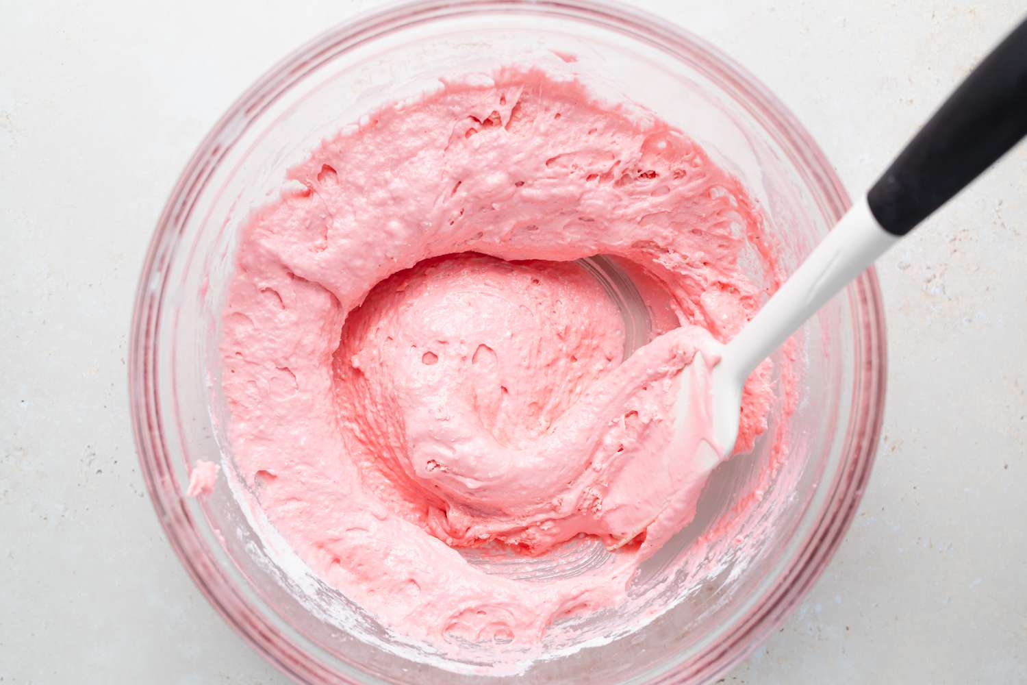 Stirring dry ingredients into meringue for macarons with raspberry filling