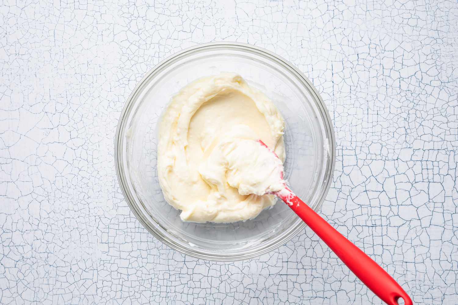 Bowl of Cream Cheese Filling With a Spatula for Strawberry Cream Cheese Cookies